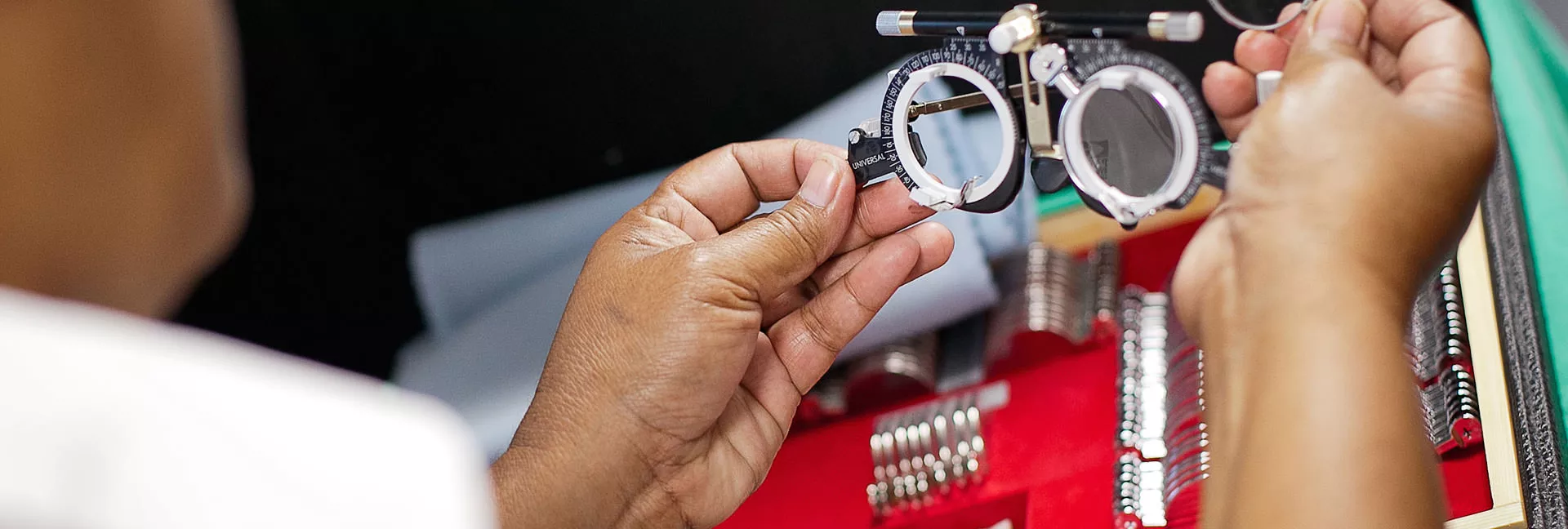 A person looking at some eye testing hardware